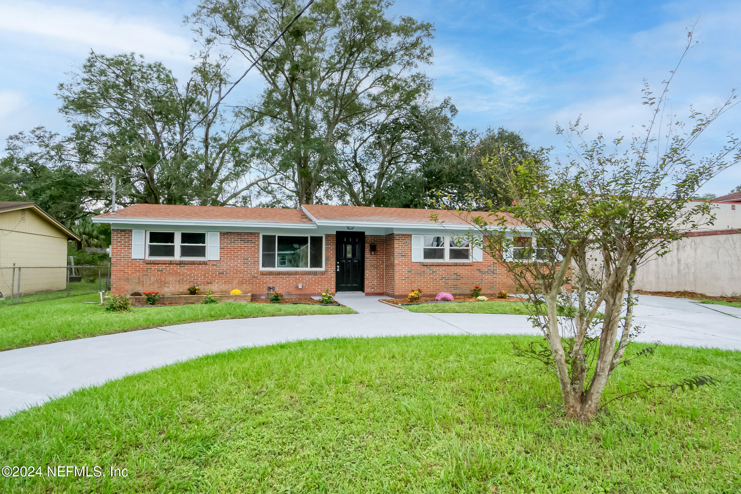 a front view of house with yard and green space