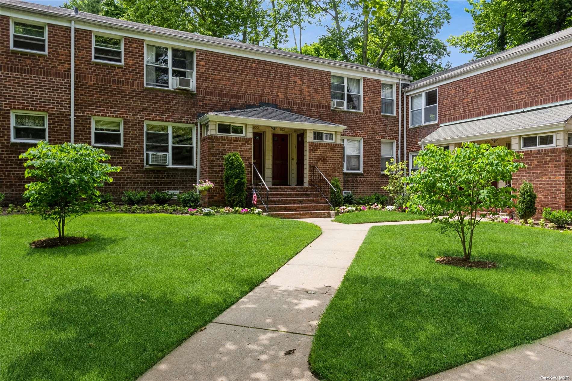 a front view of a house with a yard and porch