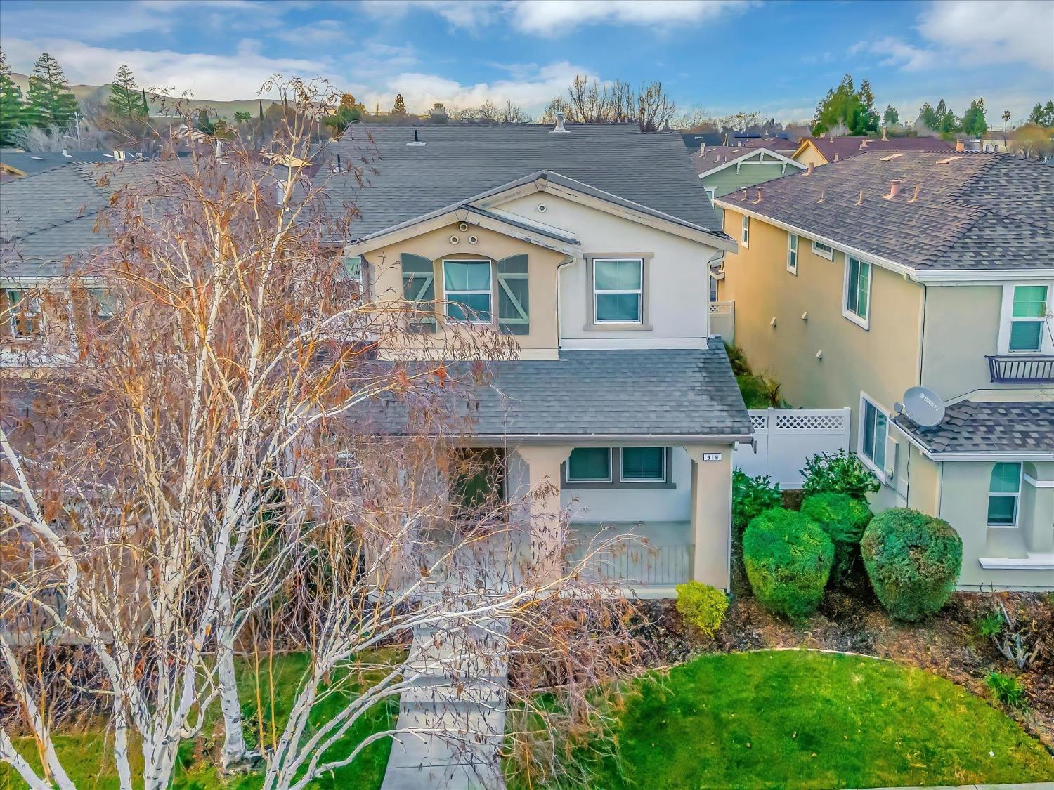 an aerial view of a house with a yard and potted plants