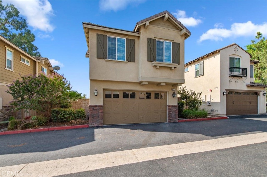 a view of a house with a yard and garage