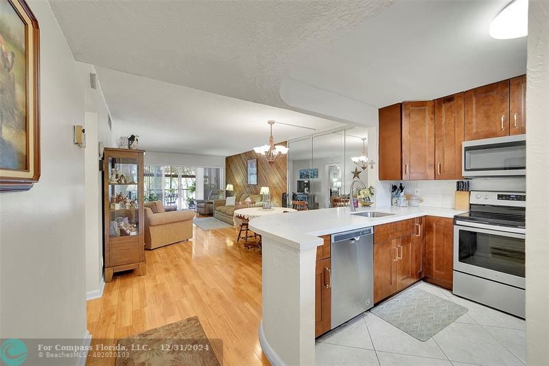 a kitchen with a sink stove and wooden cabinets