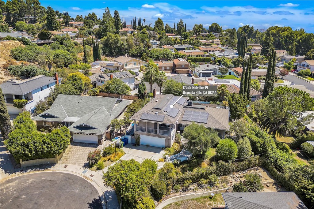 an aerial view of a residential houses with city view