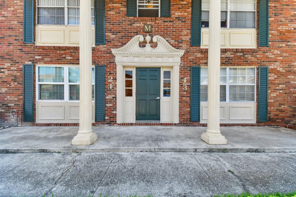 a view of a brick building with many windows