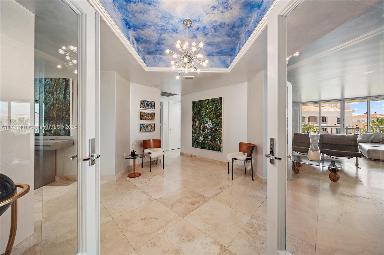 a living room with furniture and a chandelier