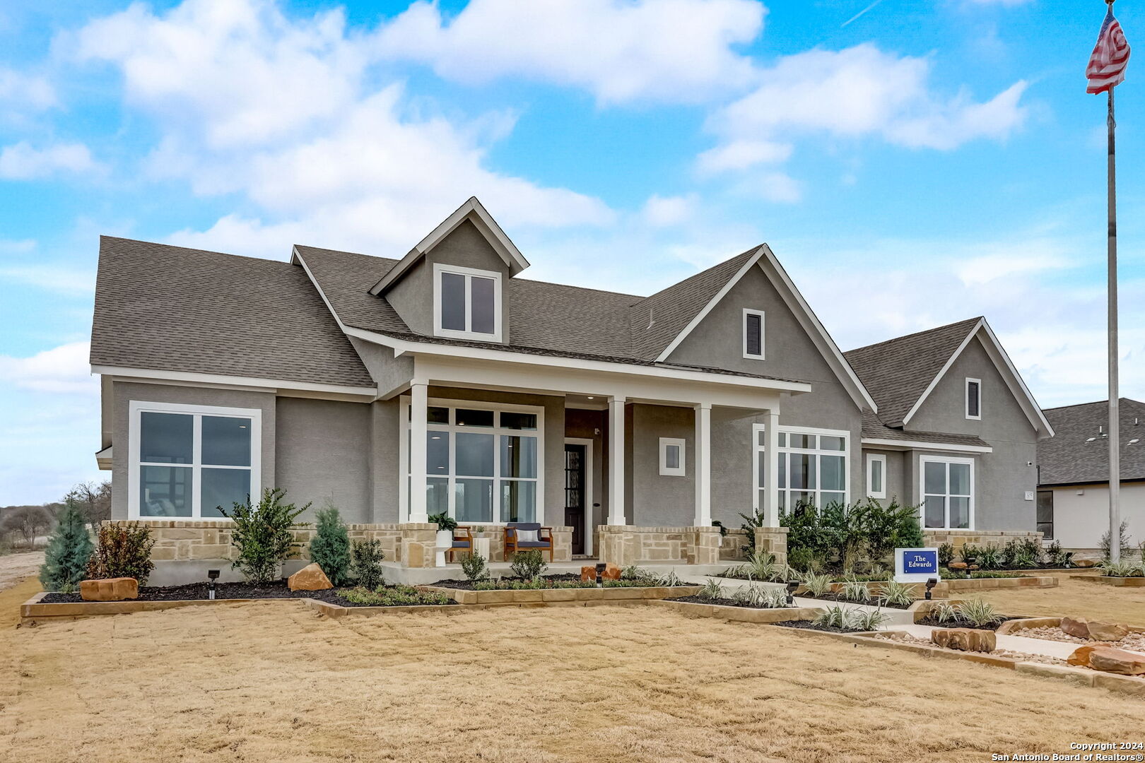 a front view of a house with yard and seating