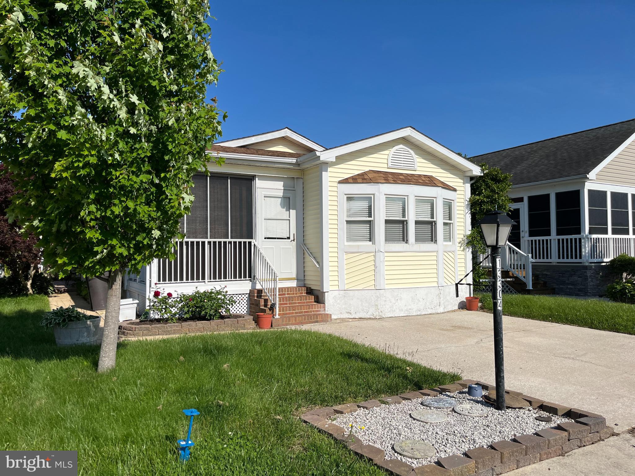 a front view of a house with a garden and plants