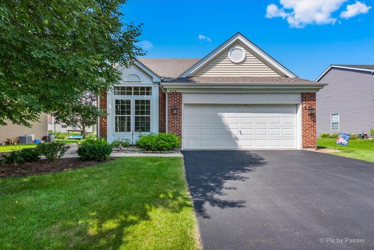 a front view of a house with a yard and garage