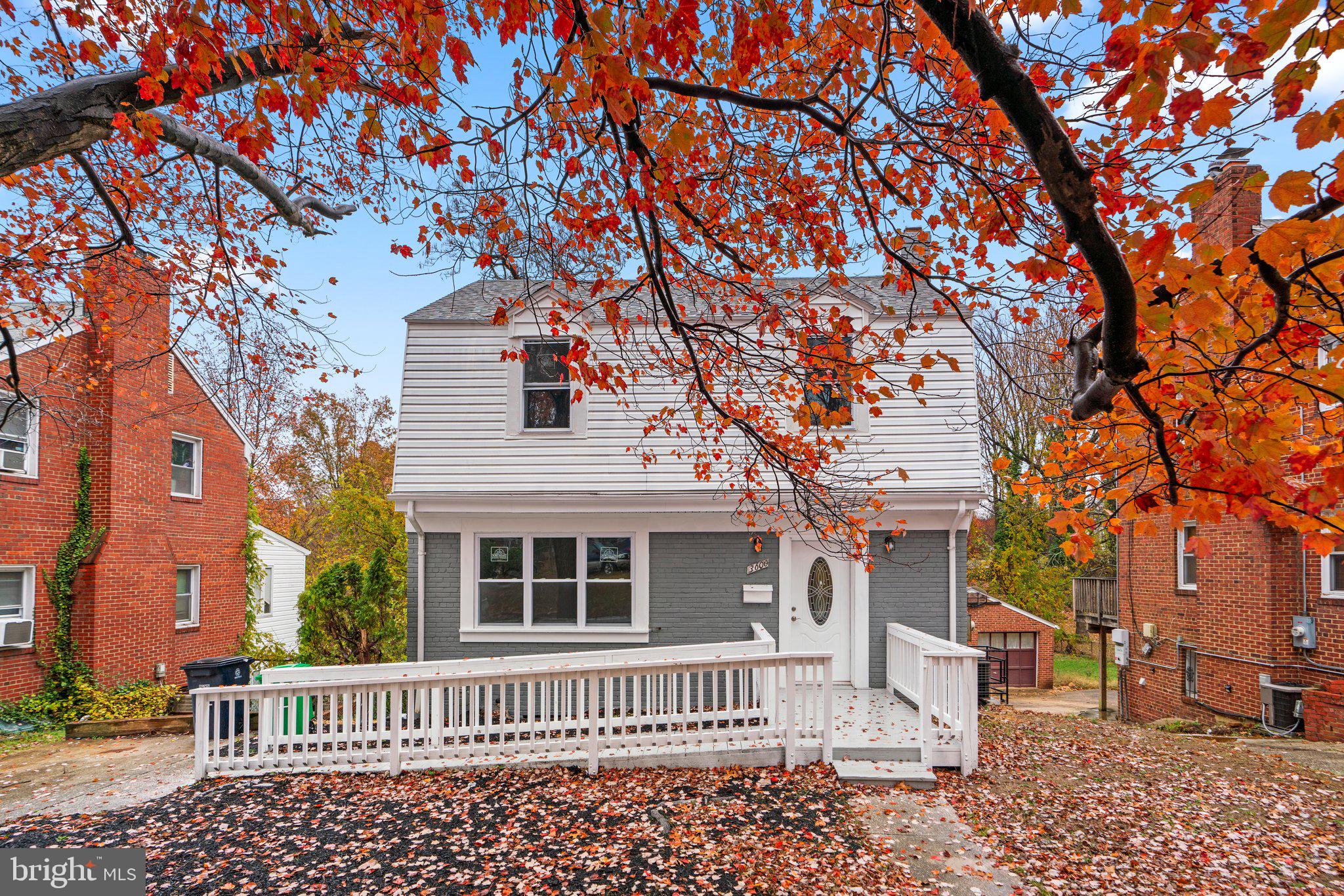 front view of a house with a bench