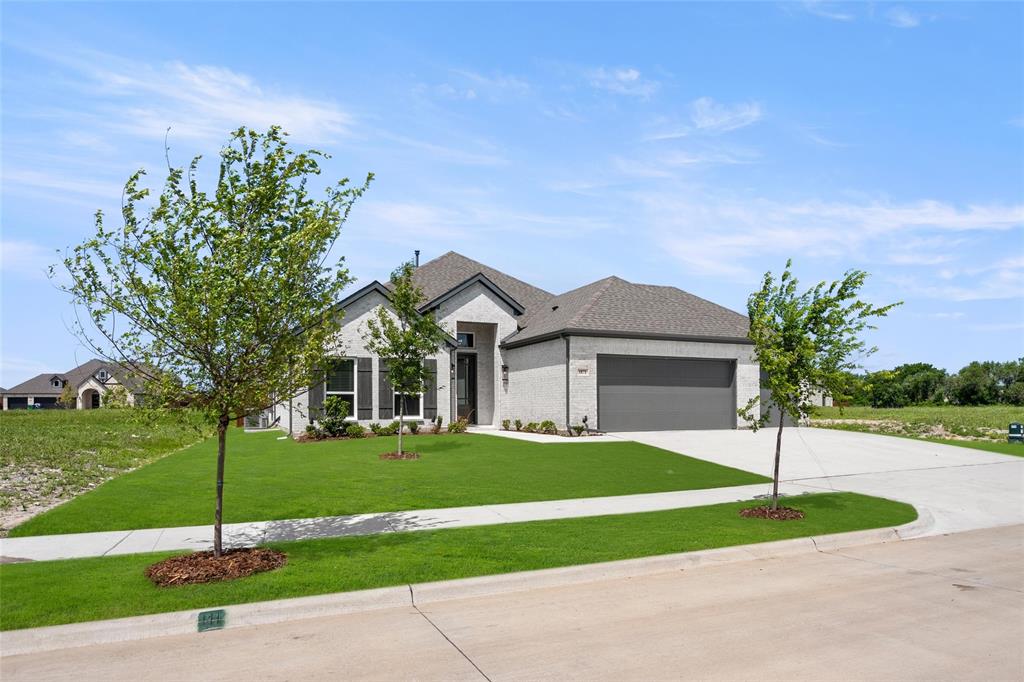 a front view of a house with a yard and garage