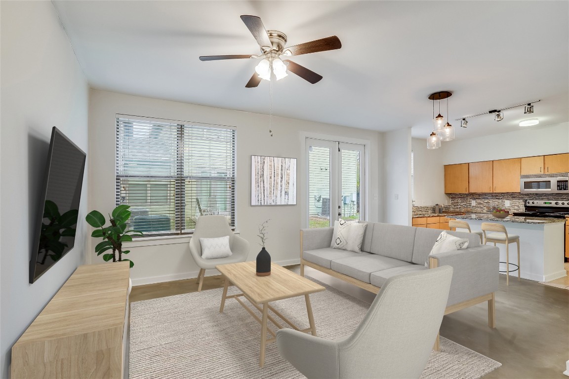 a living room with furniture a flat screen tv and a large window