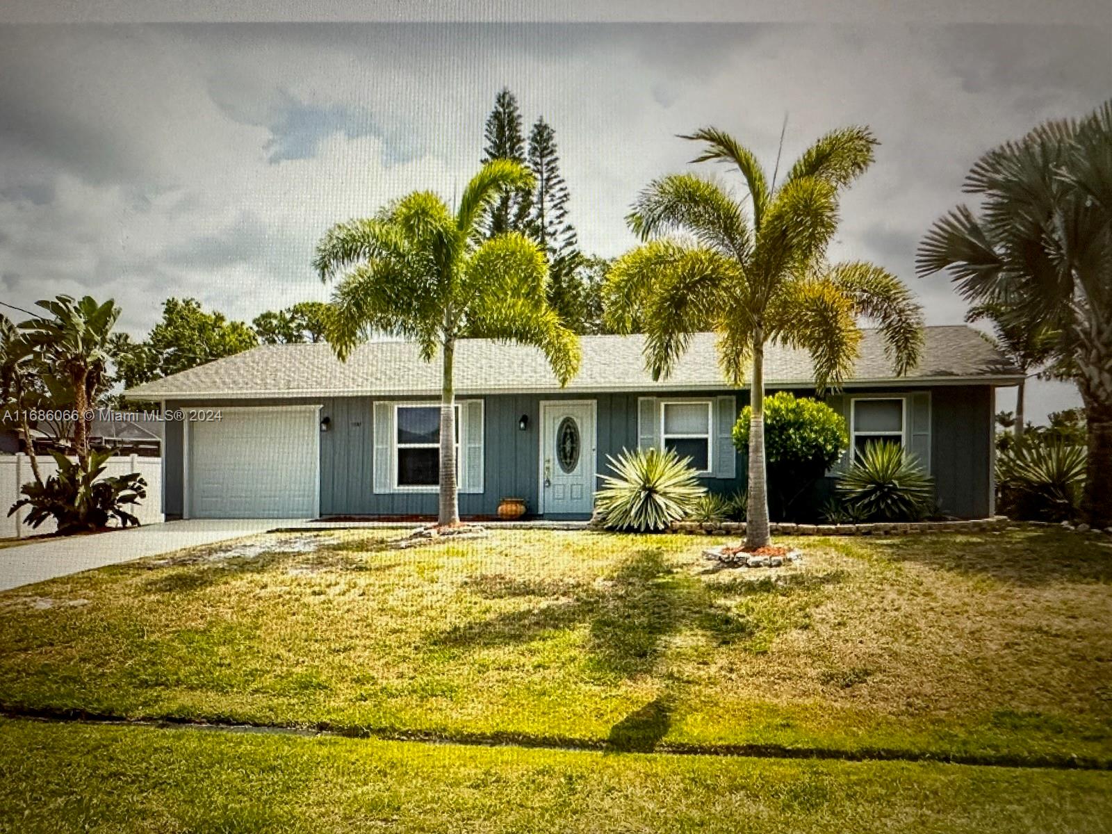 a yellow house with trees in front of it