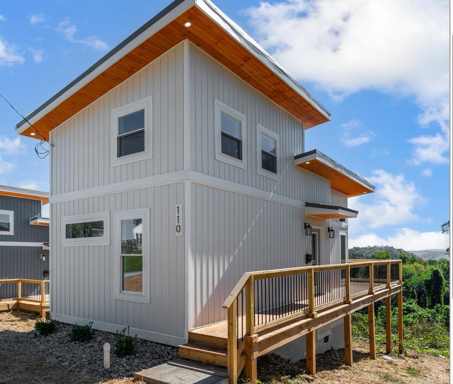 a view of house with deck and outdoor seating