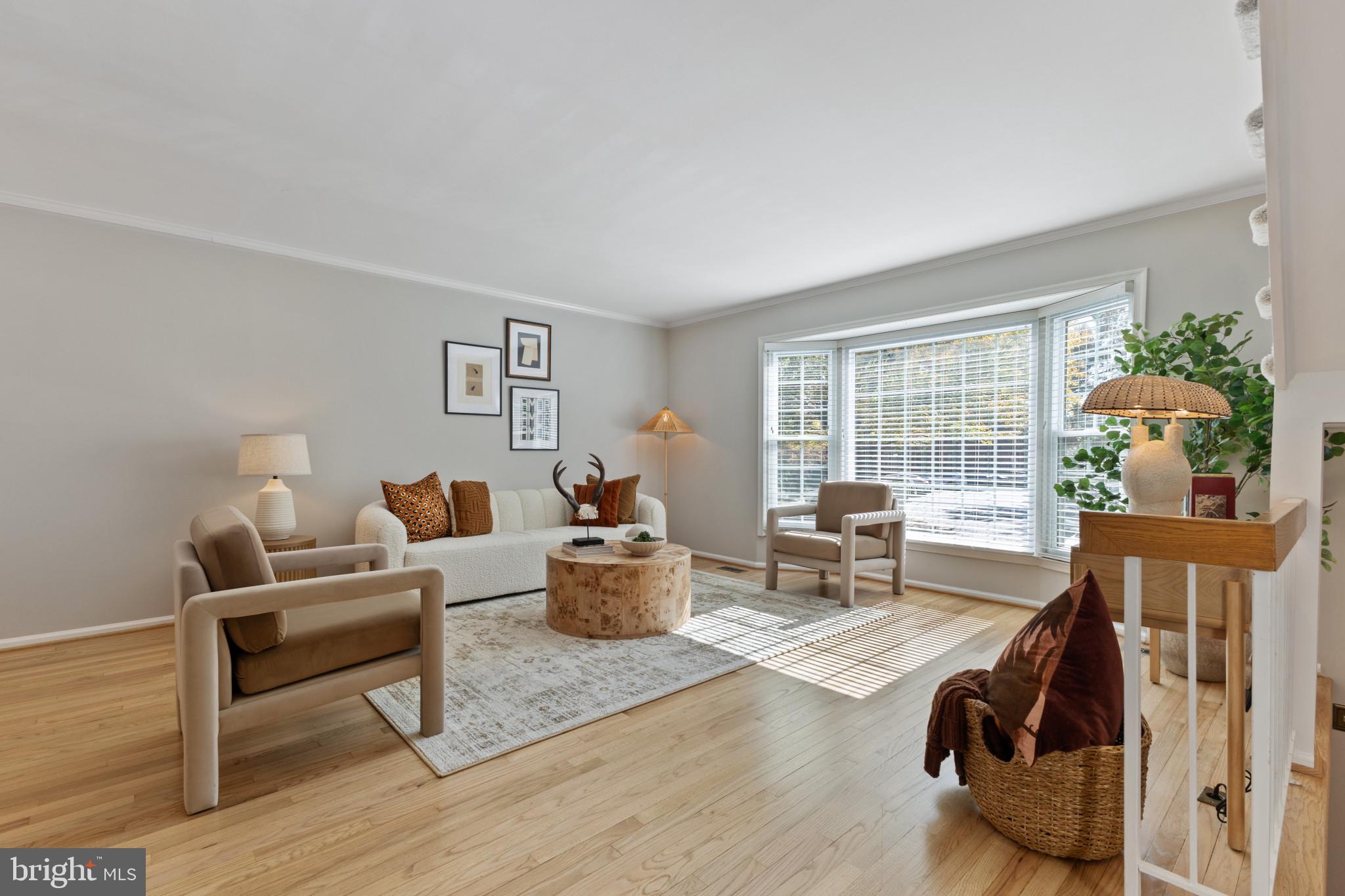 a living room with furniture a window and a table