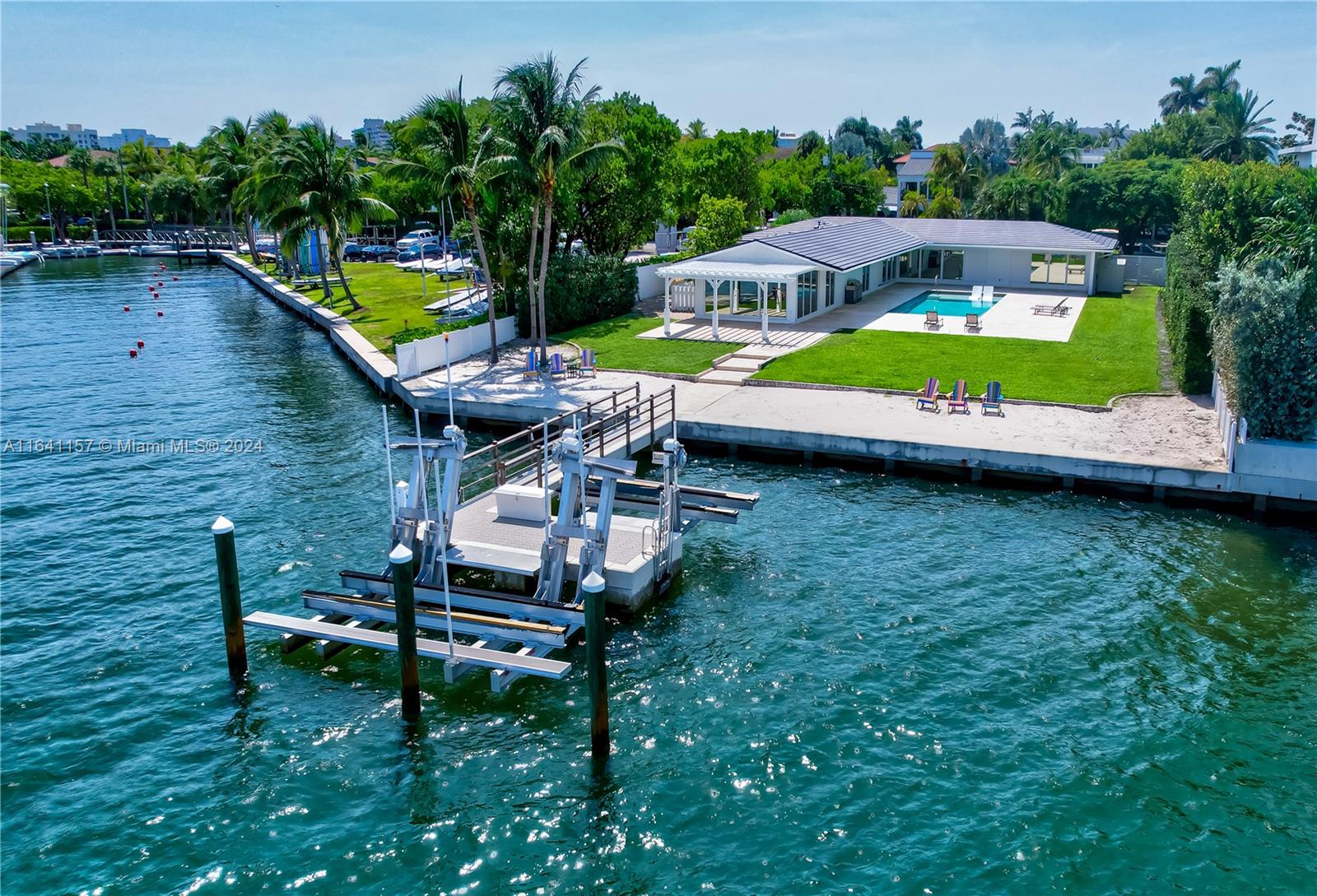 an aerial view of a house having swimming pool having outdoor seating