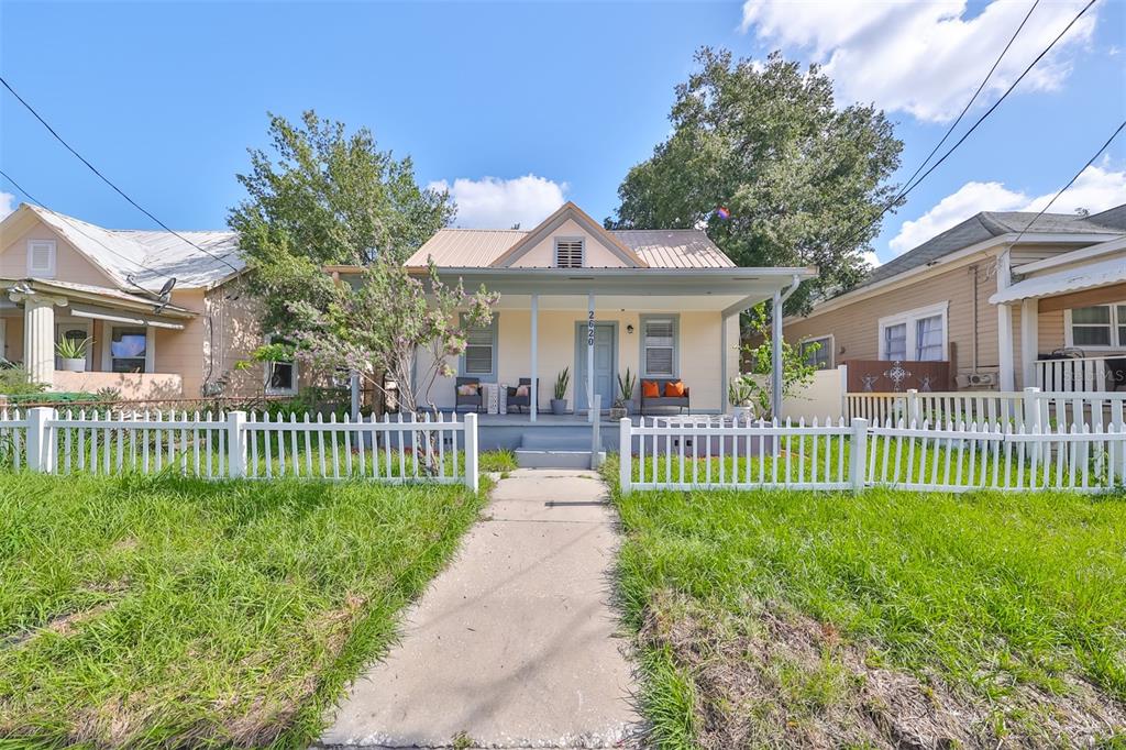 a view of a house with a yard and a garden