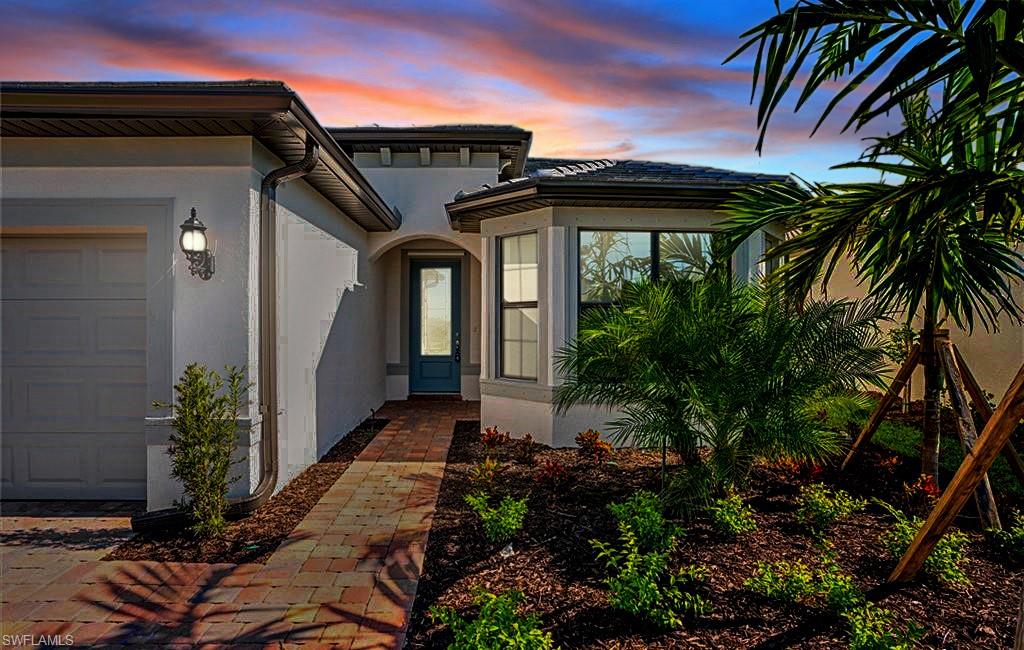 Exterior entry at dusk with a garage