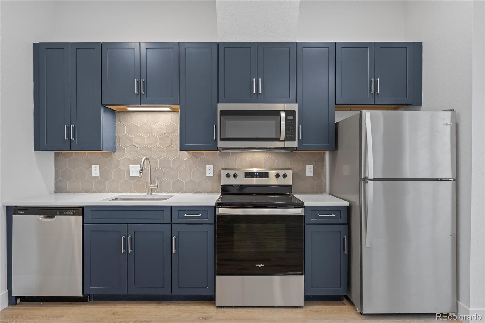 a kitchen with a sink a stove and refrigerator