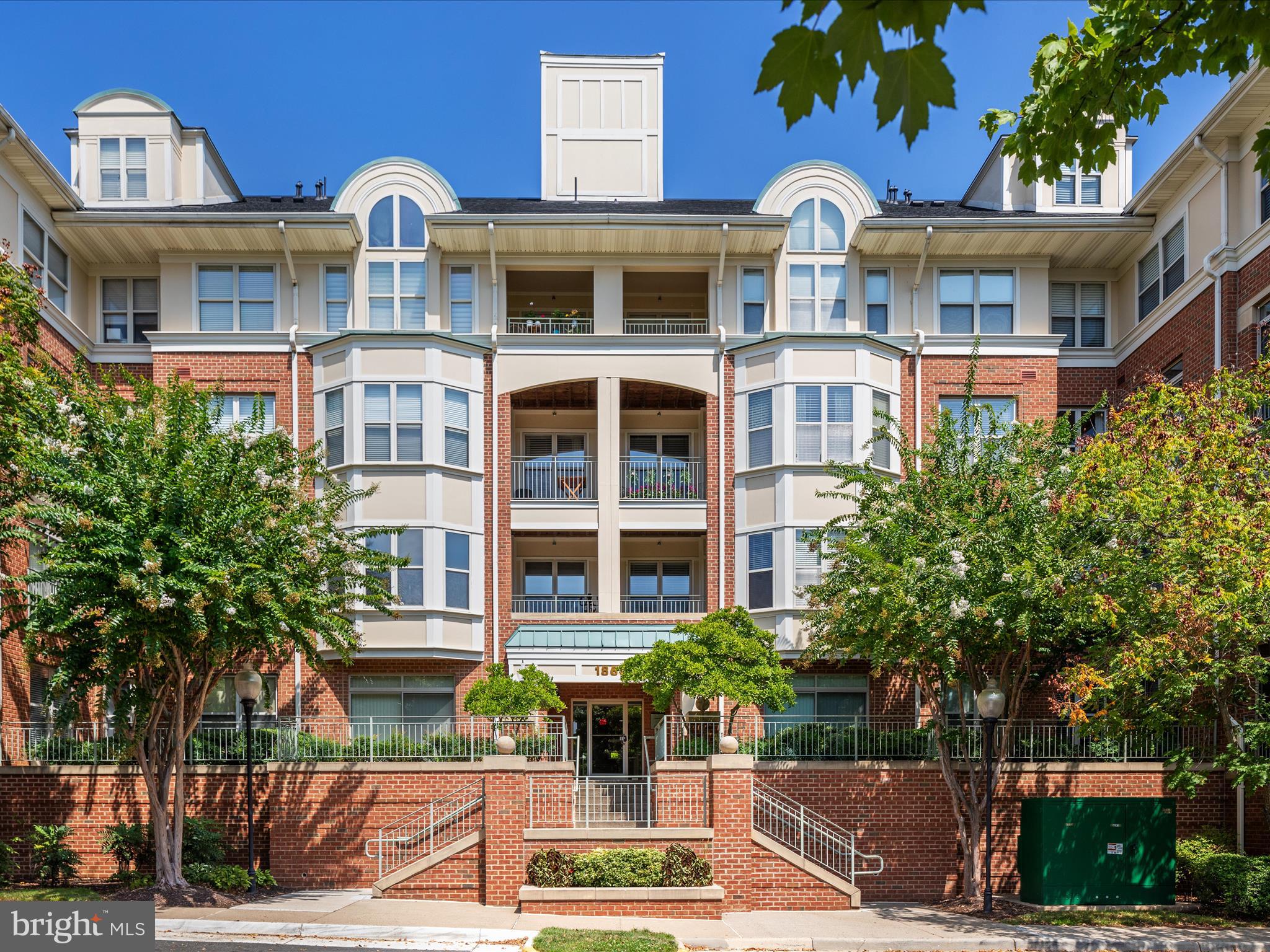 a front view of a residential apartment building with a yard