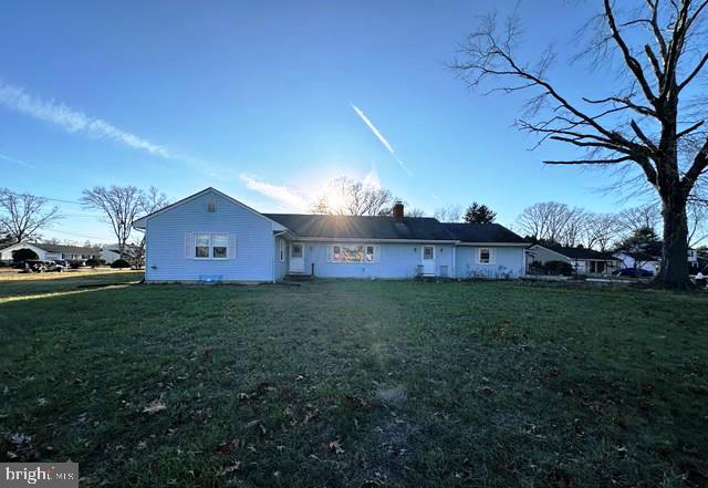 a view of a house with a yard and wooden fence