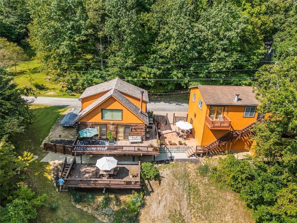 an aerial view of a house with swimming pool fire pit and outdoor seating