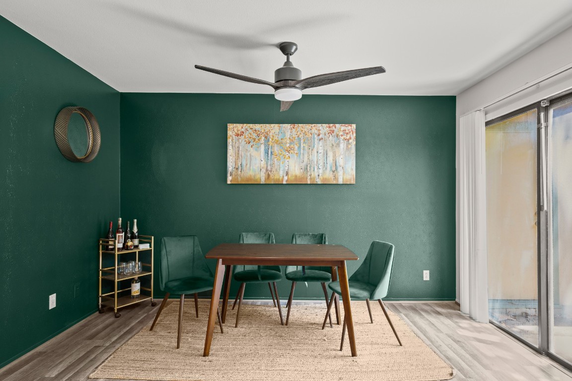 a dining room with furniture and a window