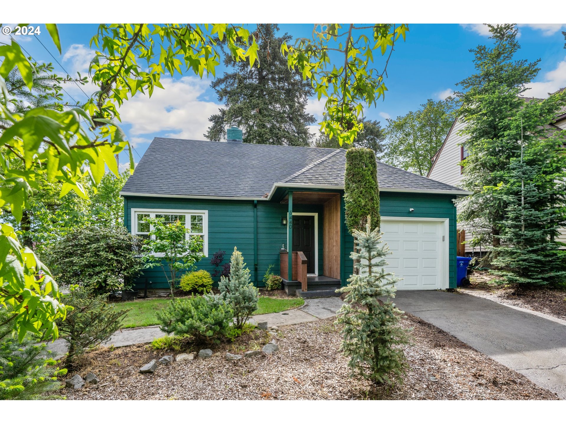 a front view of a house with a garden