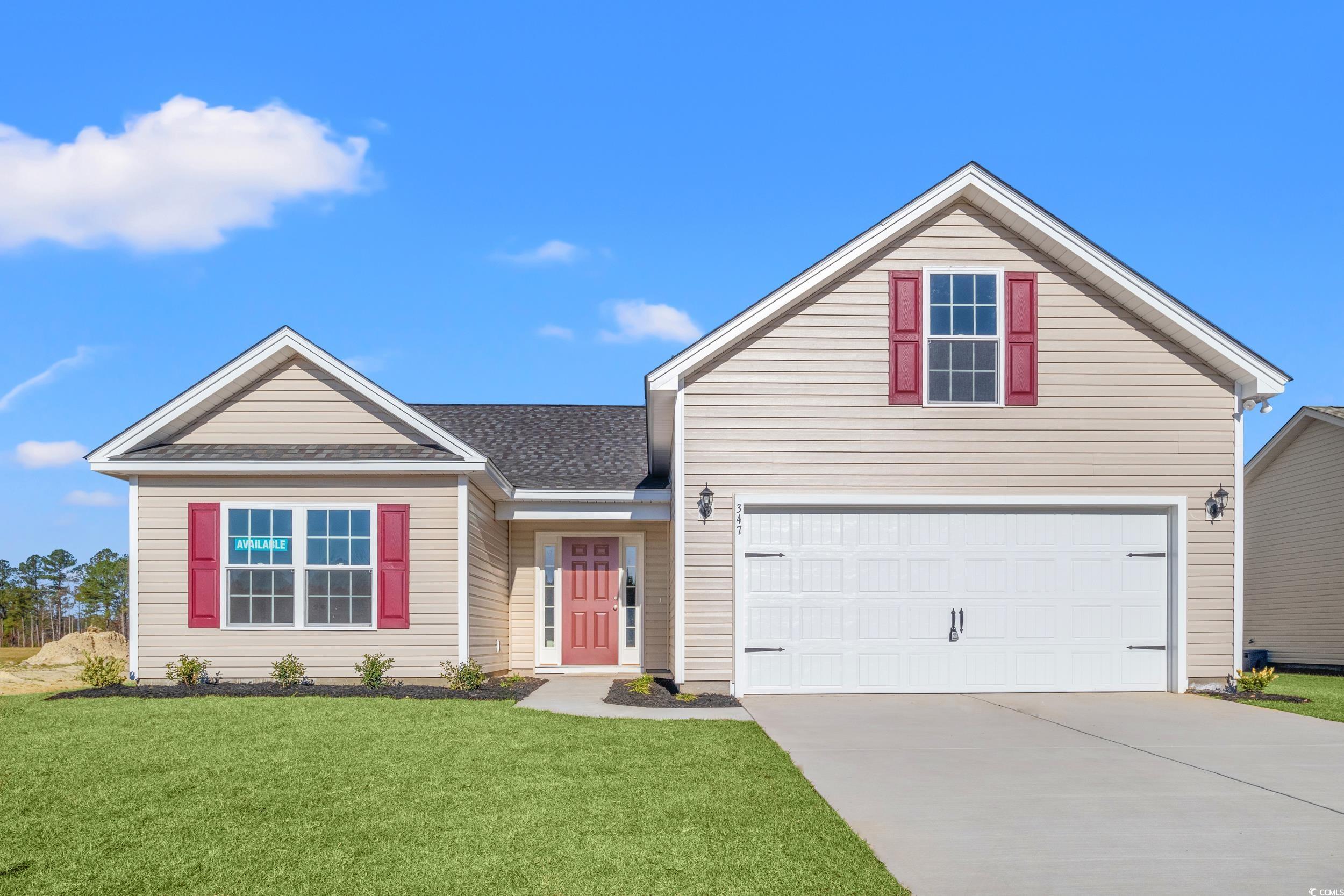 Front facade with a garage and a front lawn