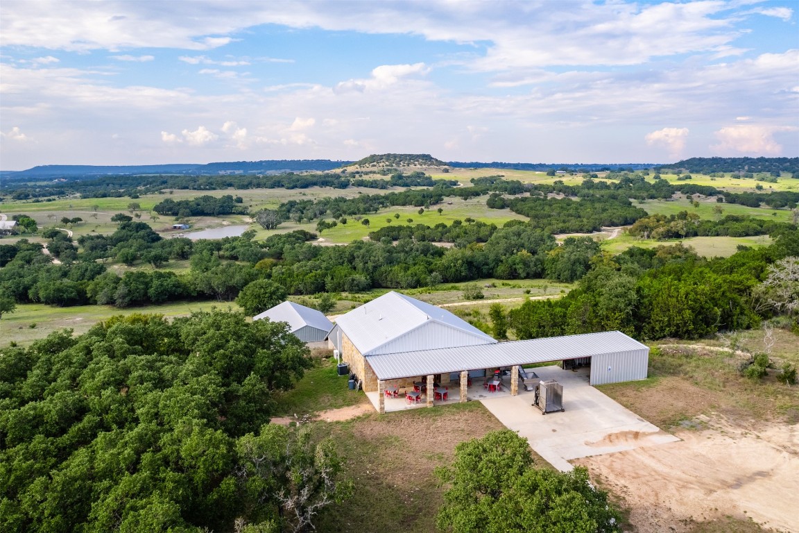 an aerial view of a house with a yard garage and lake view