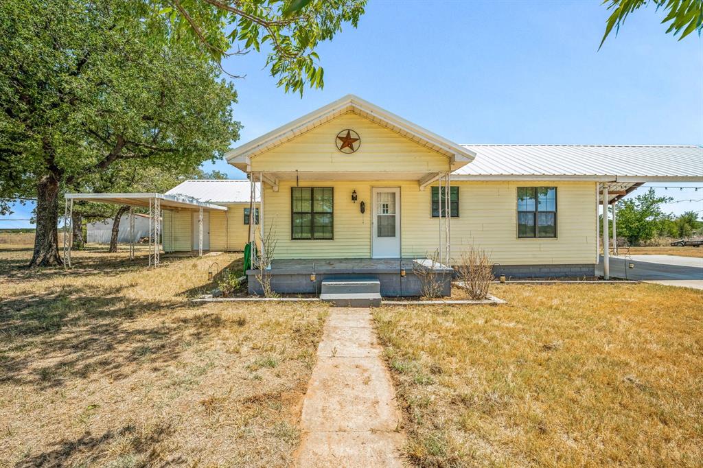 a view of house with yard