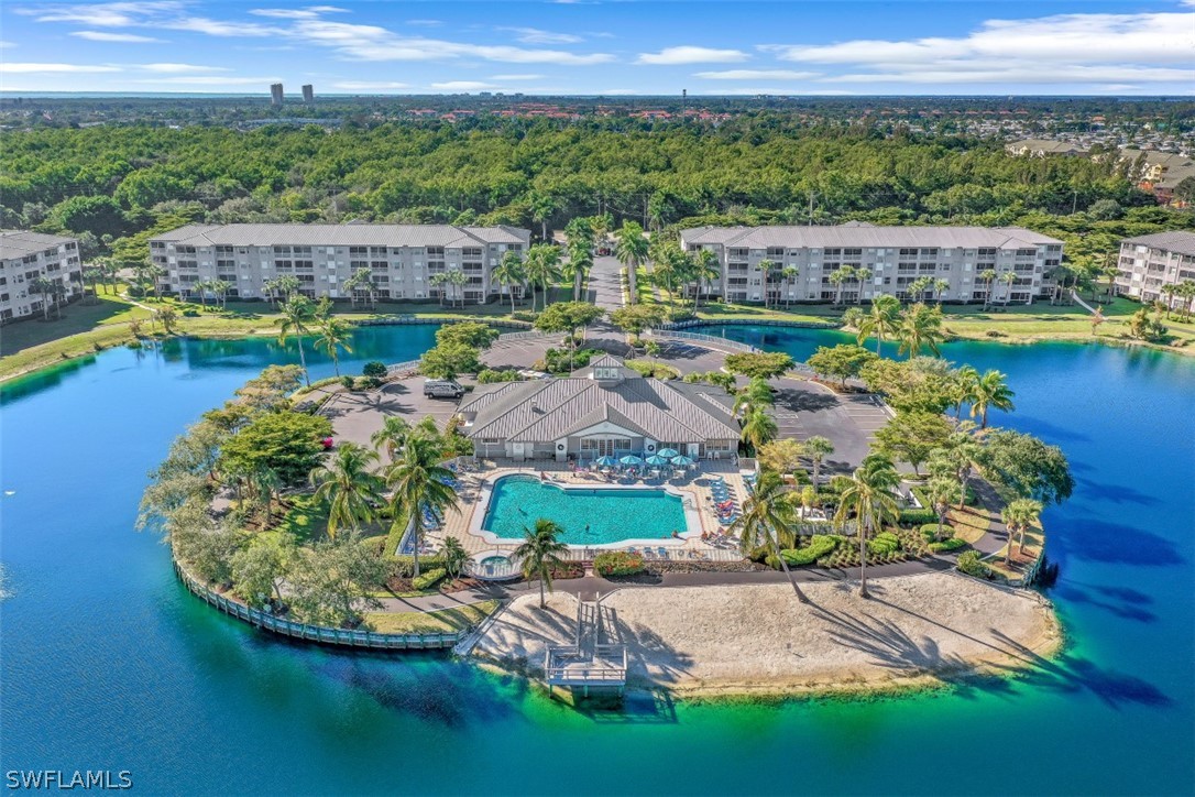 an aerial view of residential houses with outdoor space and swimming pool