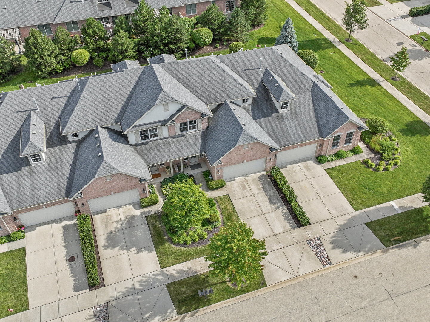 an aerial view of multiple houses with a yard