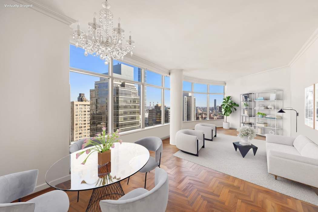 a living room with furniture a chandelier and a large mirror