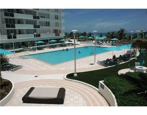 a view of a swimming pool with chairs