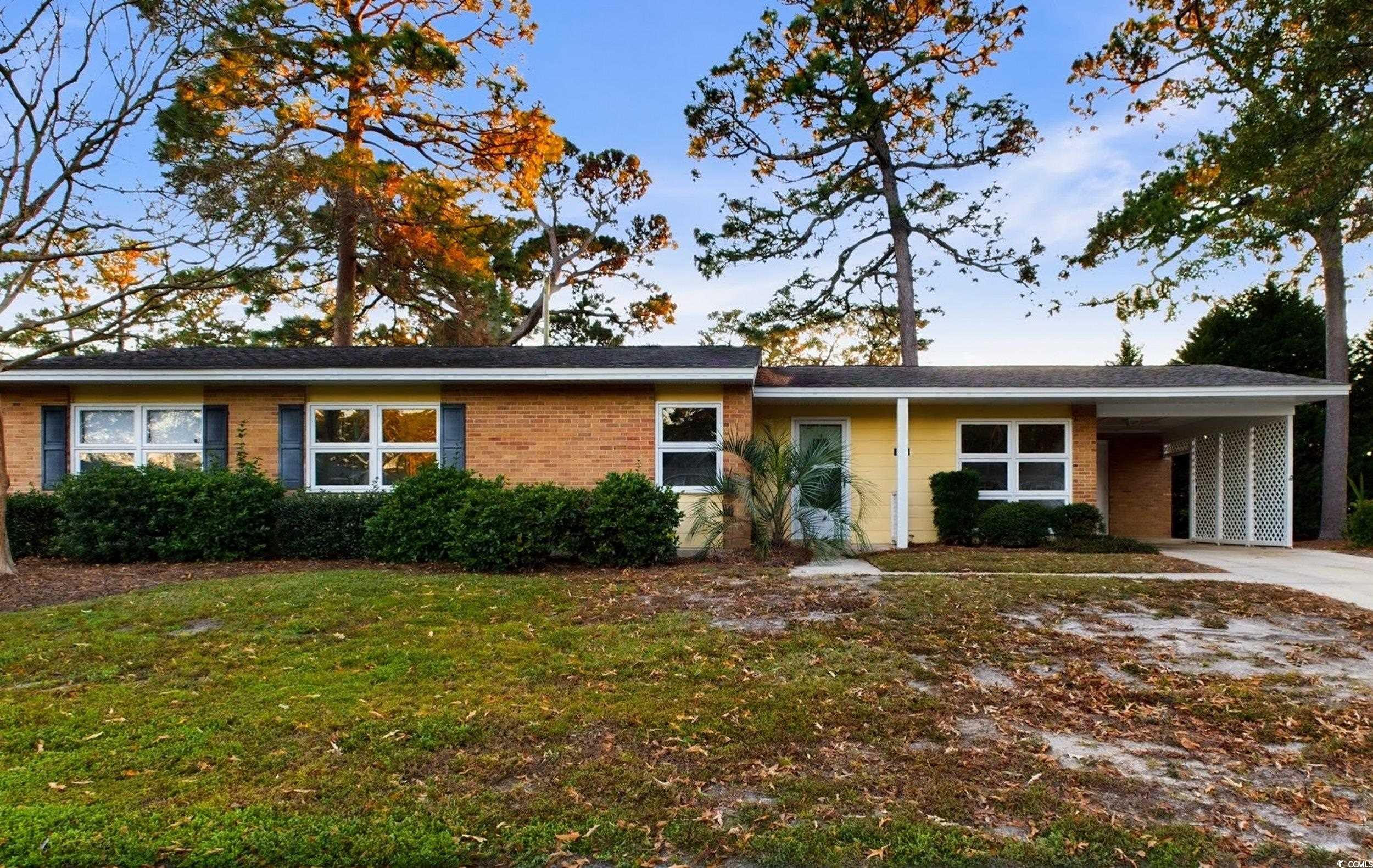 Ranch-style duplex featuring a carport and a front