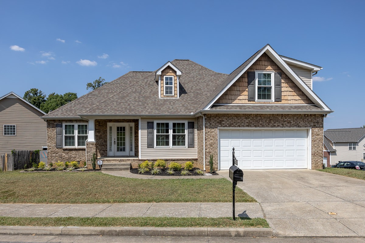 a front view of a house with a yard and garage