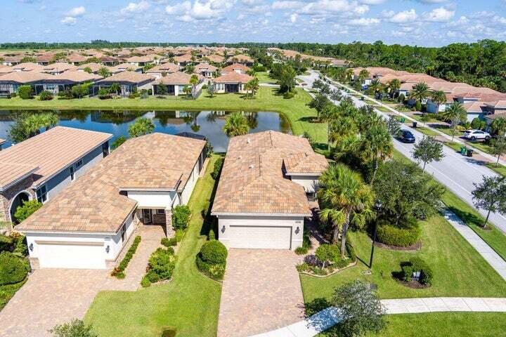 an aerial view of a house with outdoor space and lake view