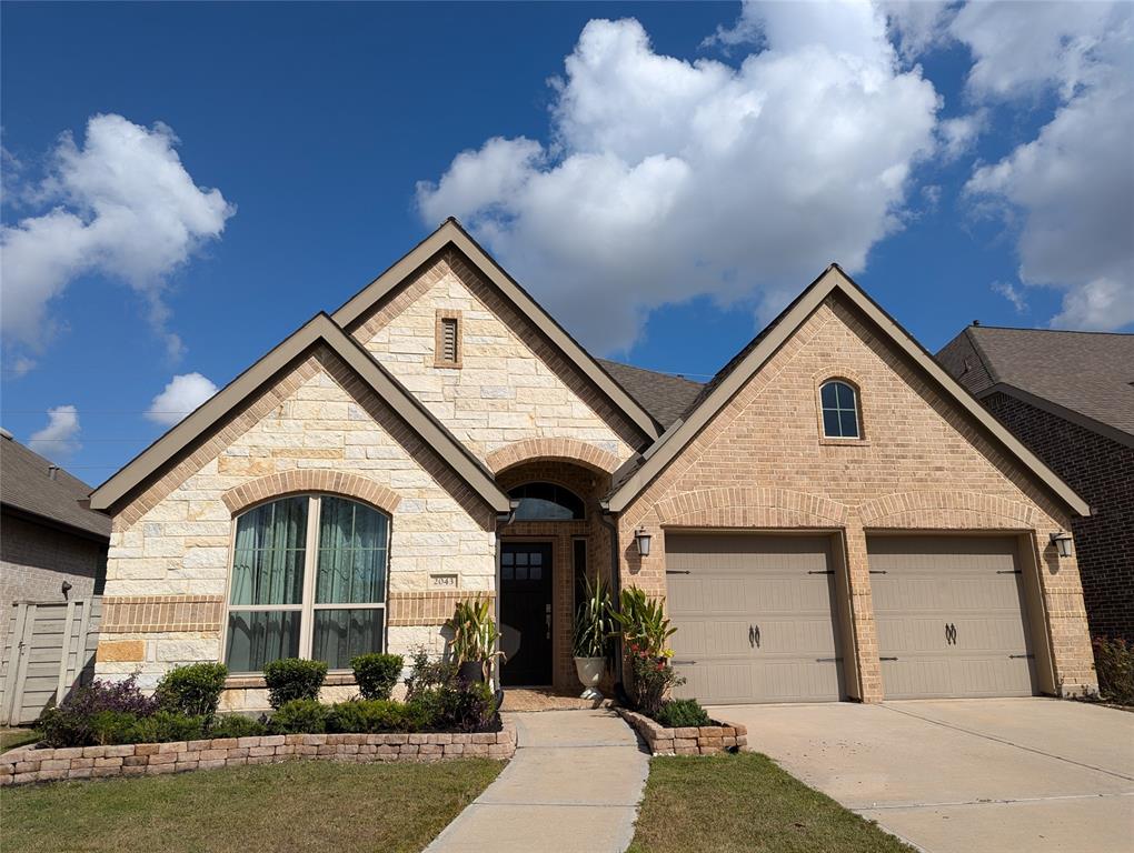 a front view of a house with garage