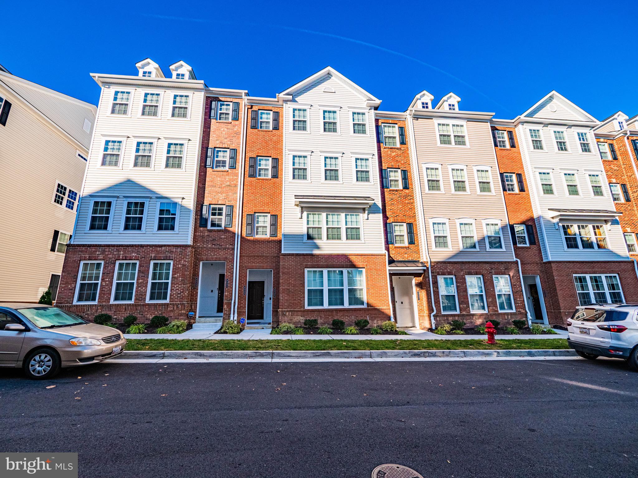 a front view of a residential apartment building with a yard