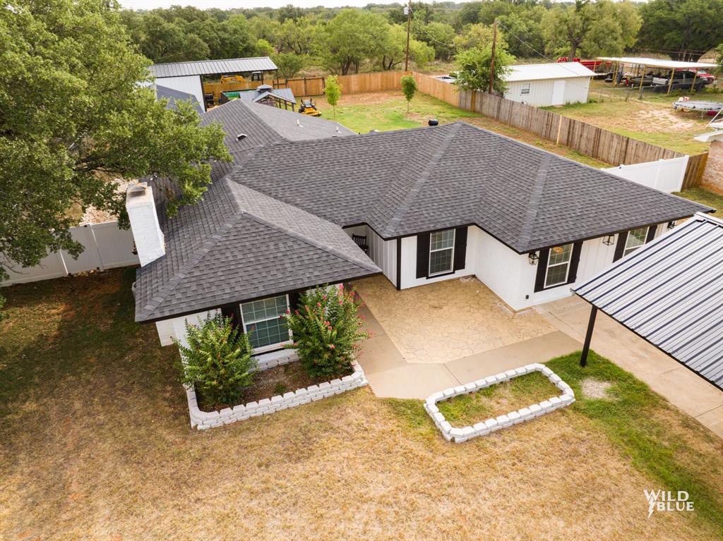 an aerial view of a house with swimming pool and patio