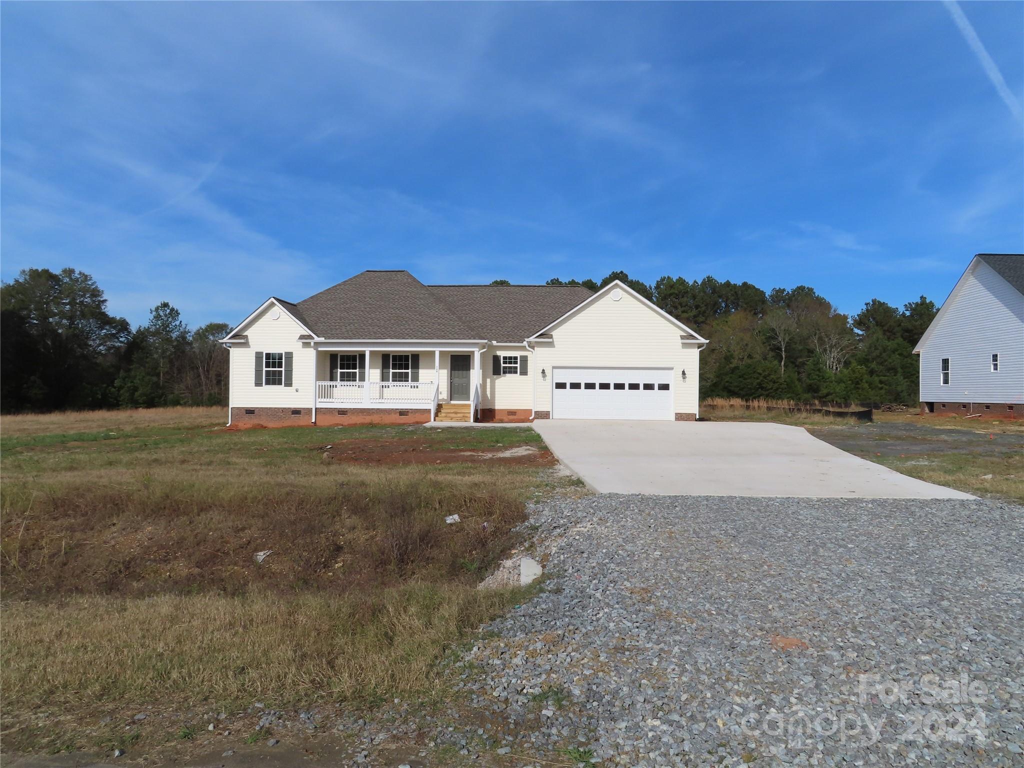 a view of house with yard and car parked