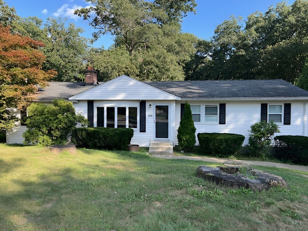 a front view of a house with a yard and porch