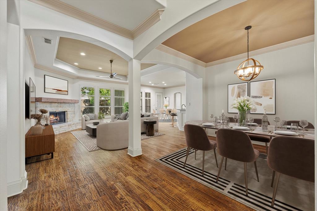 a living room with fireplace furniture and a chandelier