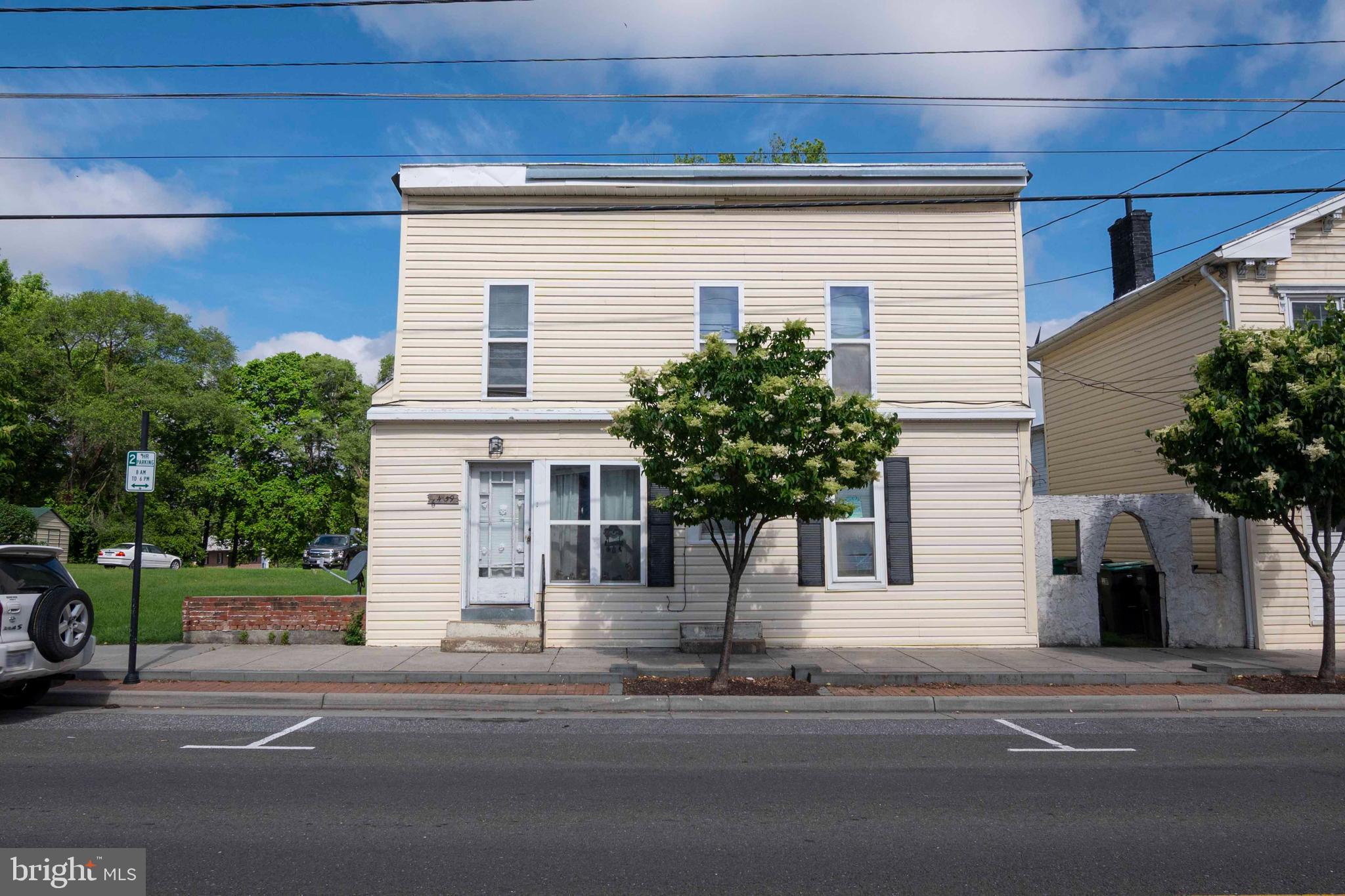 a view of a house with a yard and garage