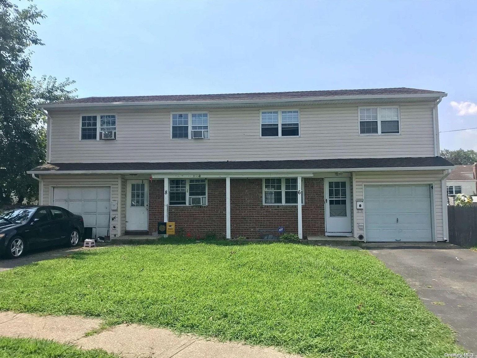 a view of a house with a yard and plants