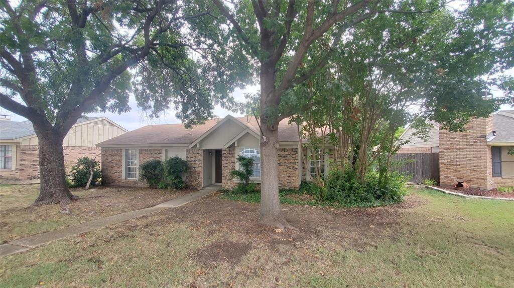 a view of a house with a tree and a yard