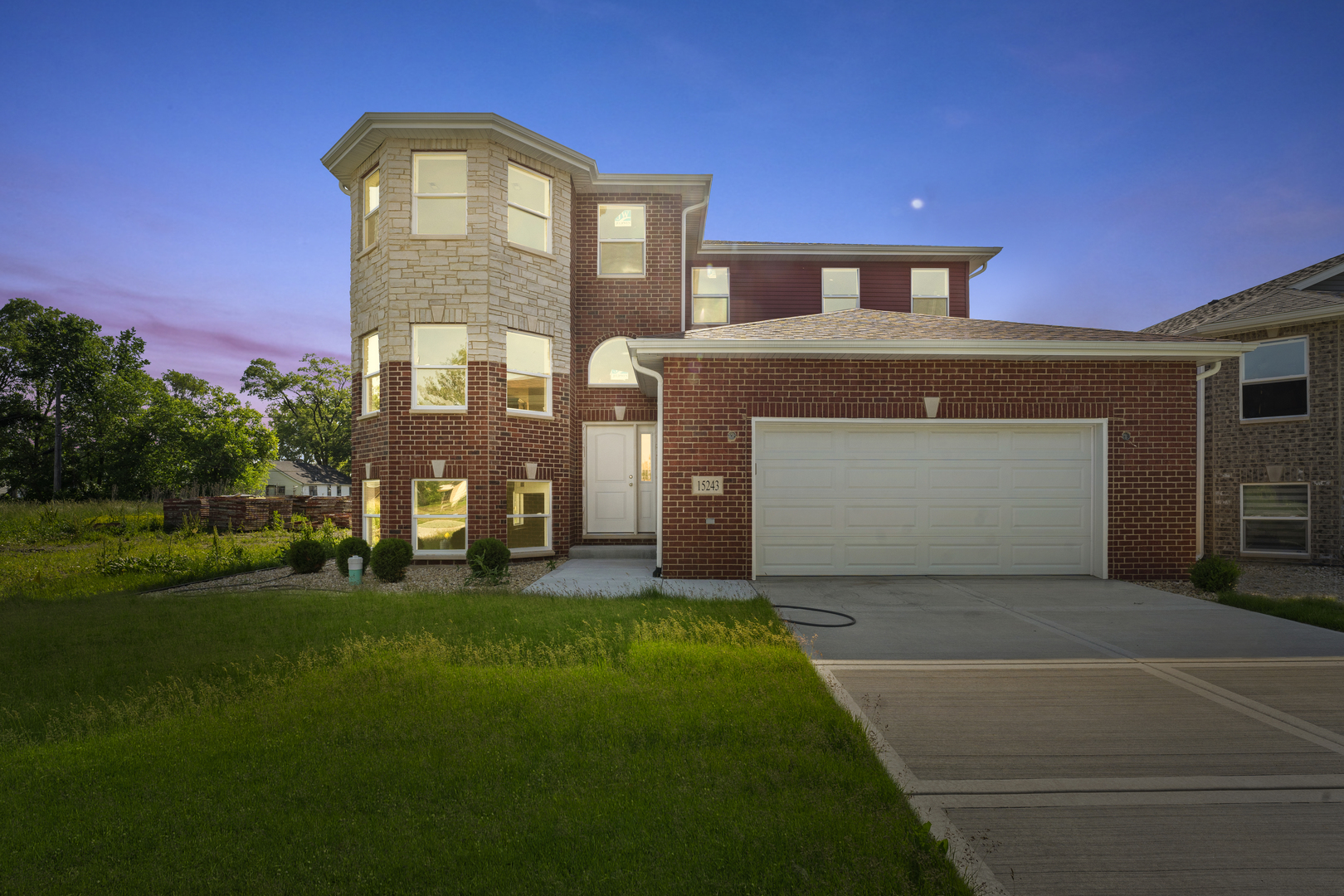 a front view of a house with a garden