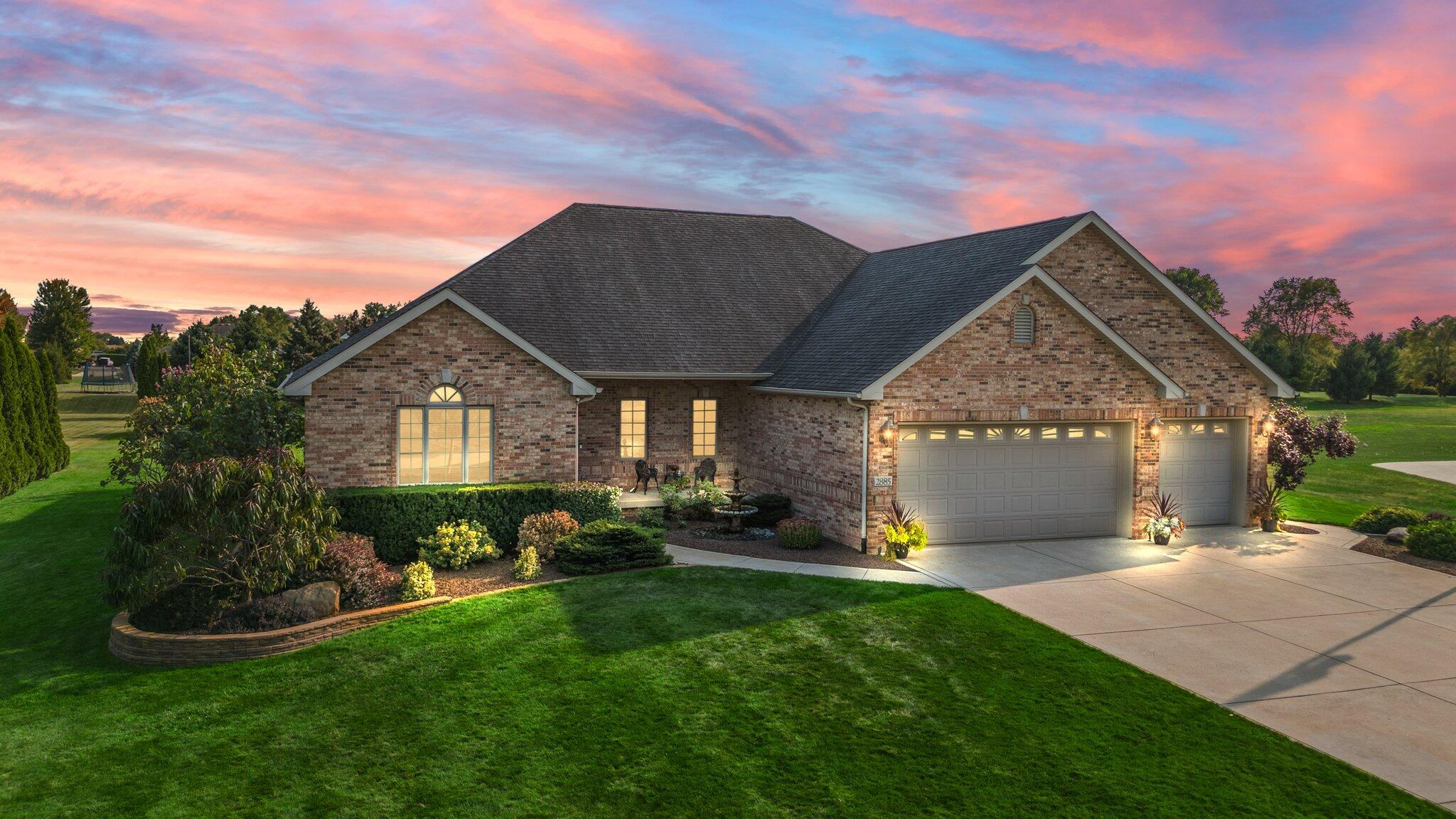 a front view of a house with a yard and garage