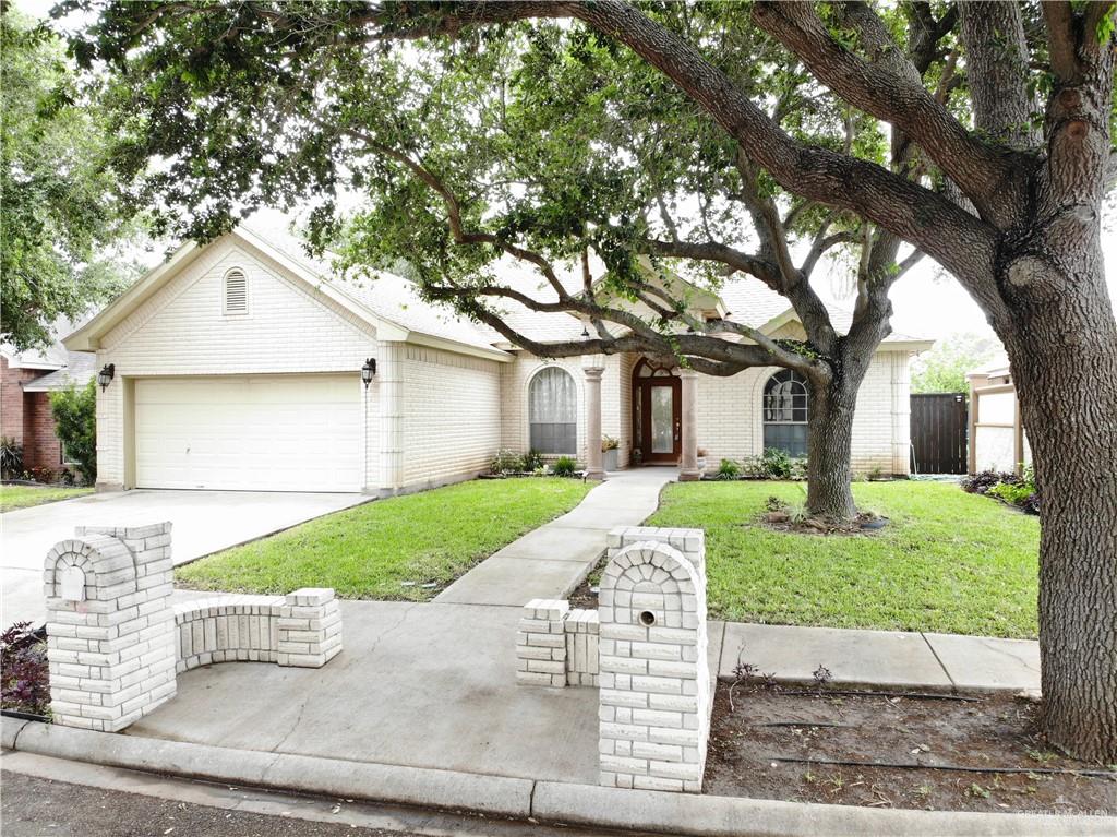 Ranch-style house with a garage and a front lawn