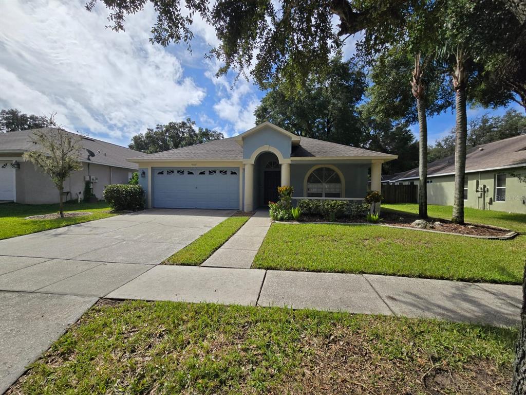 a front view of a house with a yard and garage