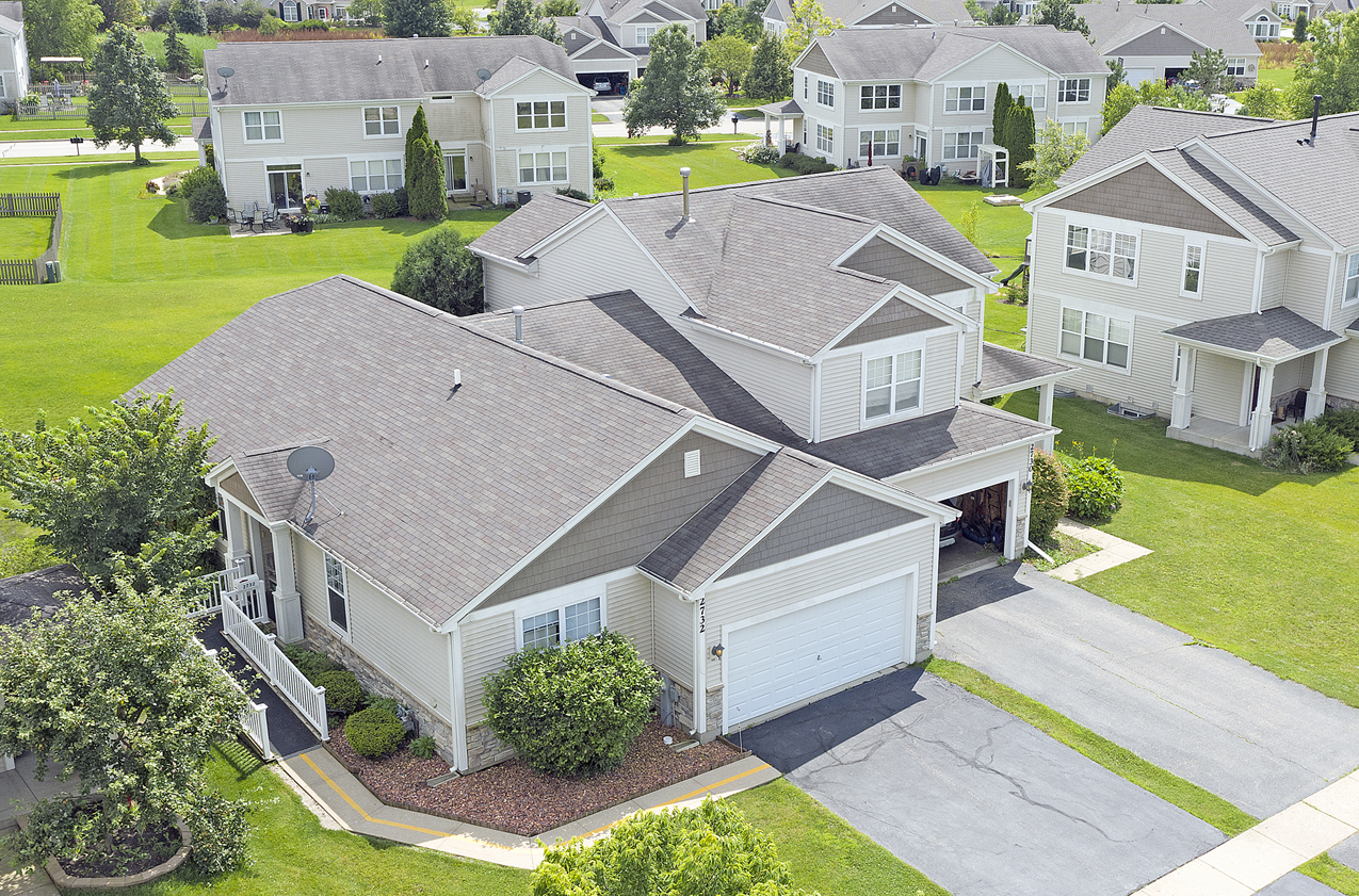 an aerial view of residential houses with yard and swimming pool